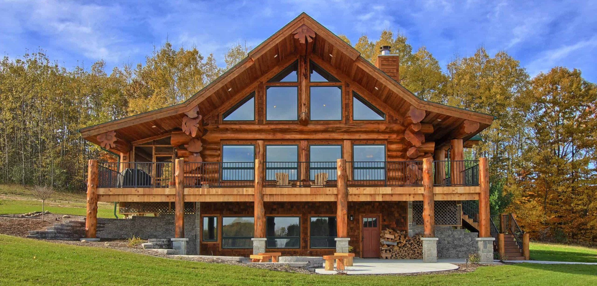 A handcrafted log home at dusk surrounded by evergreen forest